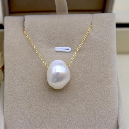 Pearl necklace on a beige display stand