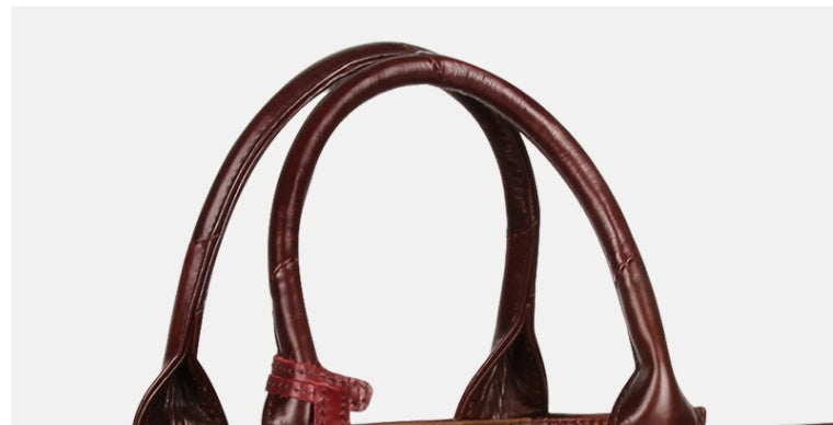 Brown leather handbag on a white background