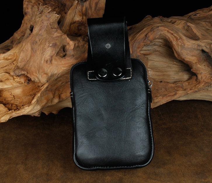 Black leather pouch on a wooden surface