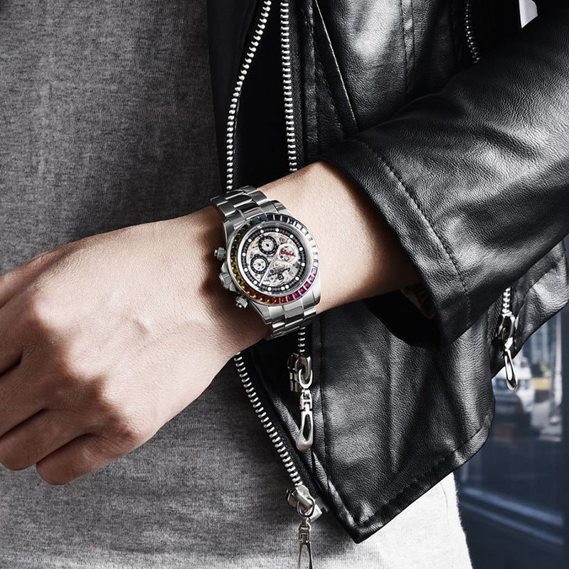 Person wearing a silver wristwatch with a detailed face, dressed in a black leather jacket.