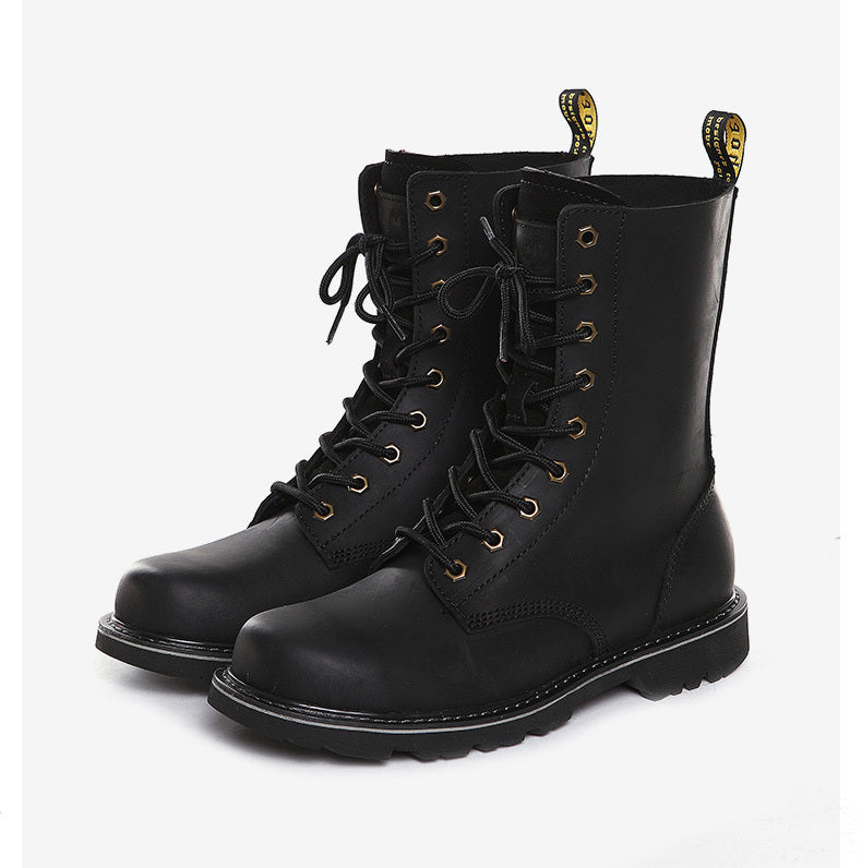 Pair of black leather boots with yellow laces on a white background