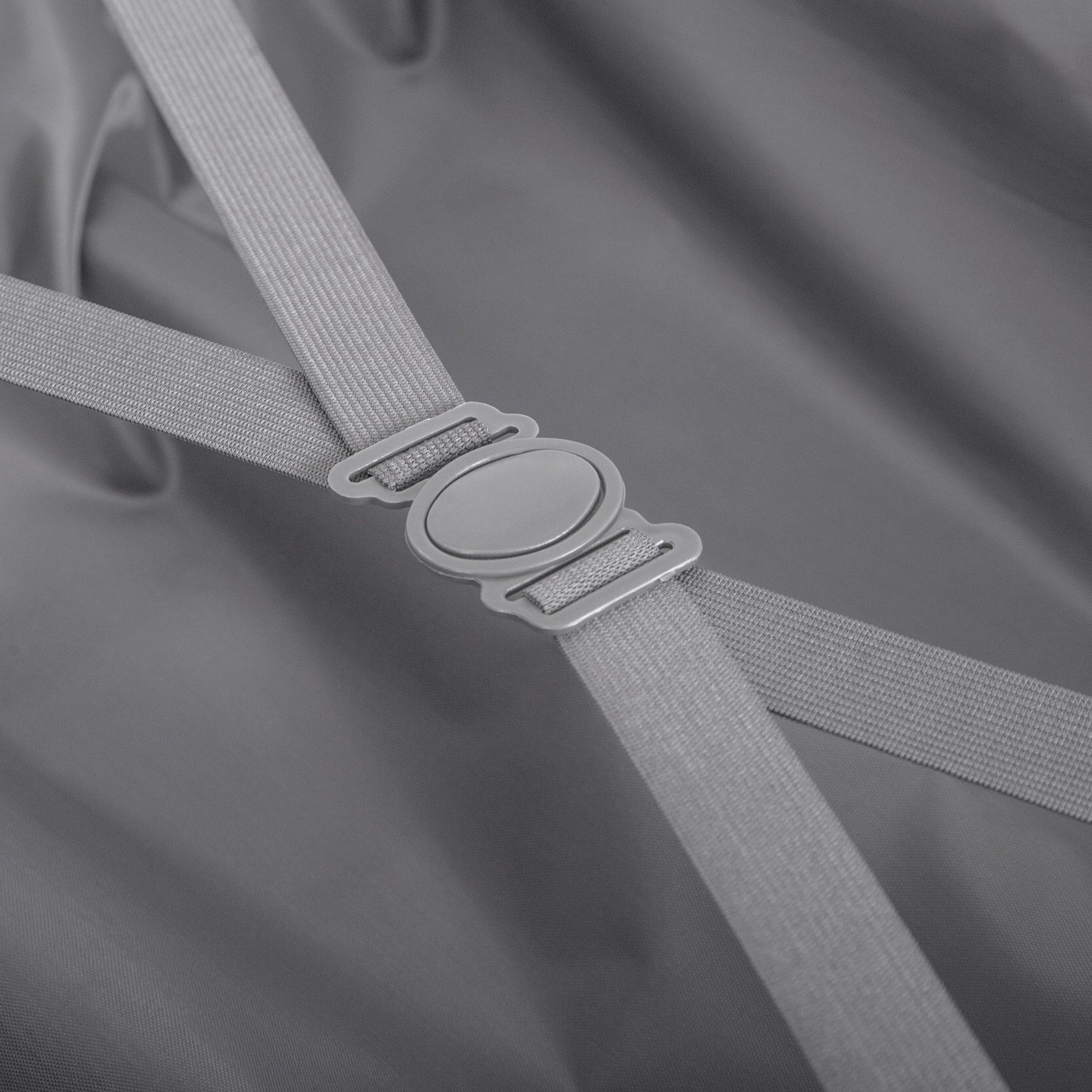 Close-up of a gray strap with a metal buckle on a gray background