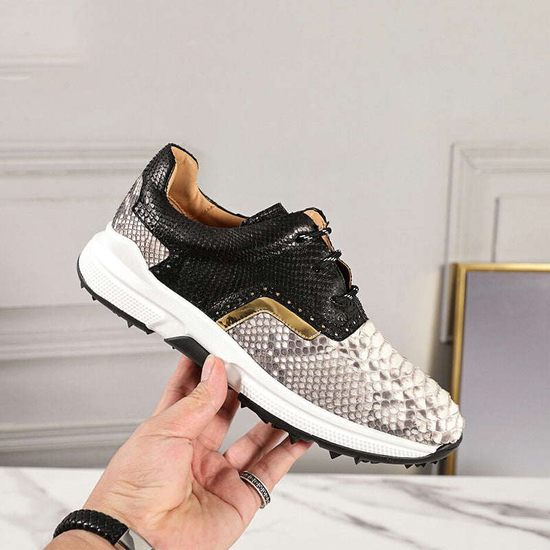 Black and white sneaker held by a hand against a neutral background