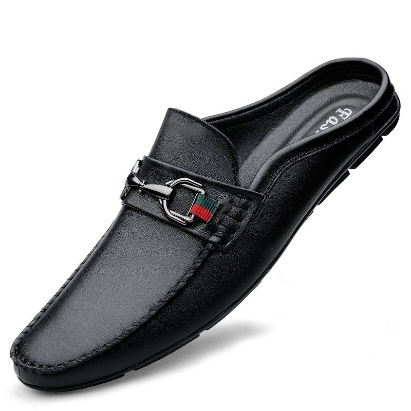 Black slip-on loafer with a silver buckle on a white background