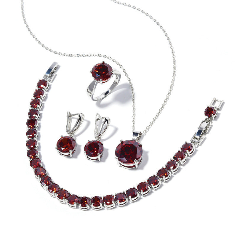 Jewelry set with red gemstones and silver accents on a white background