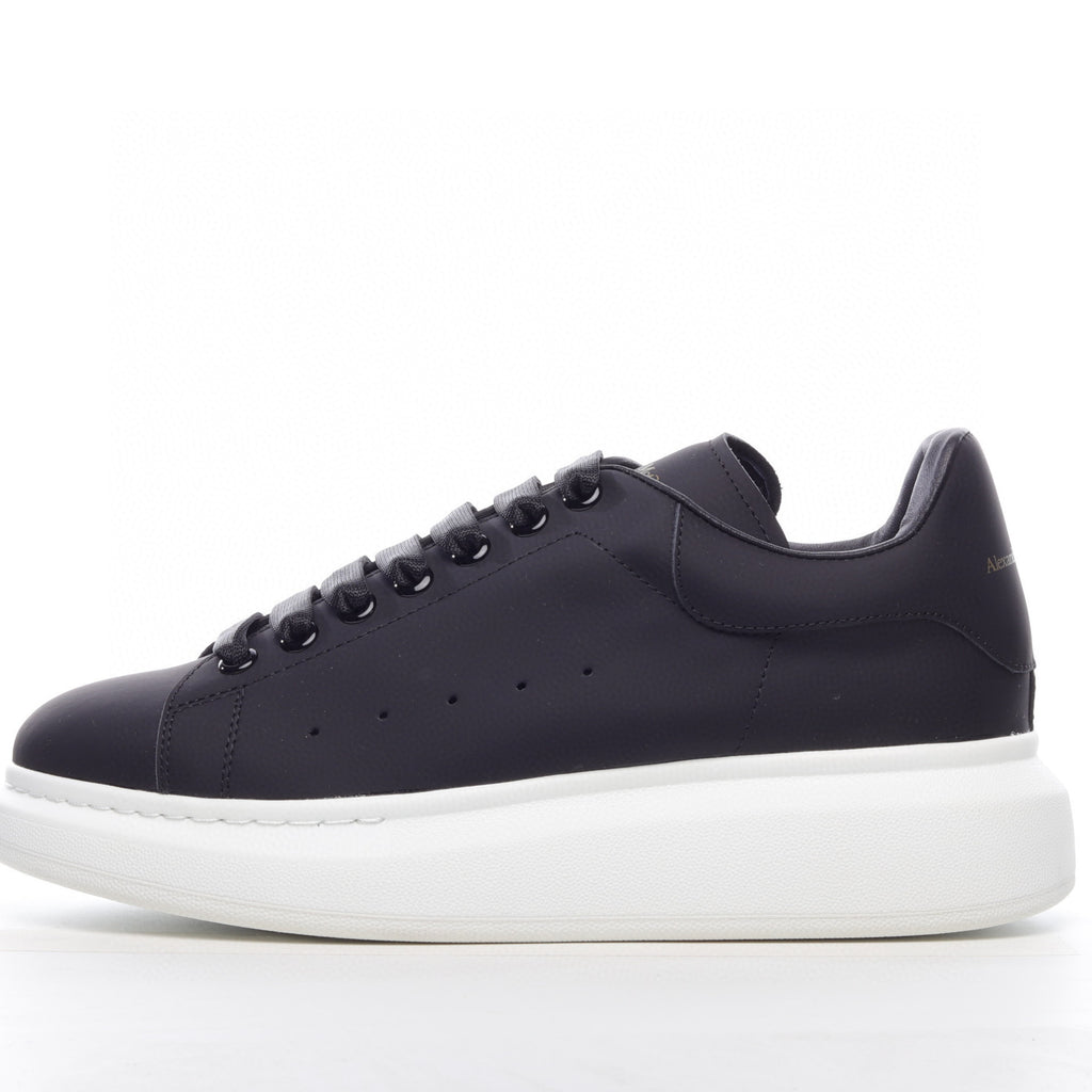 Black sneaker with white sole on a white background