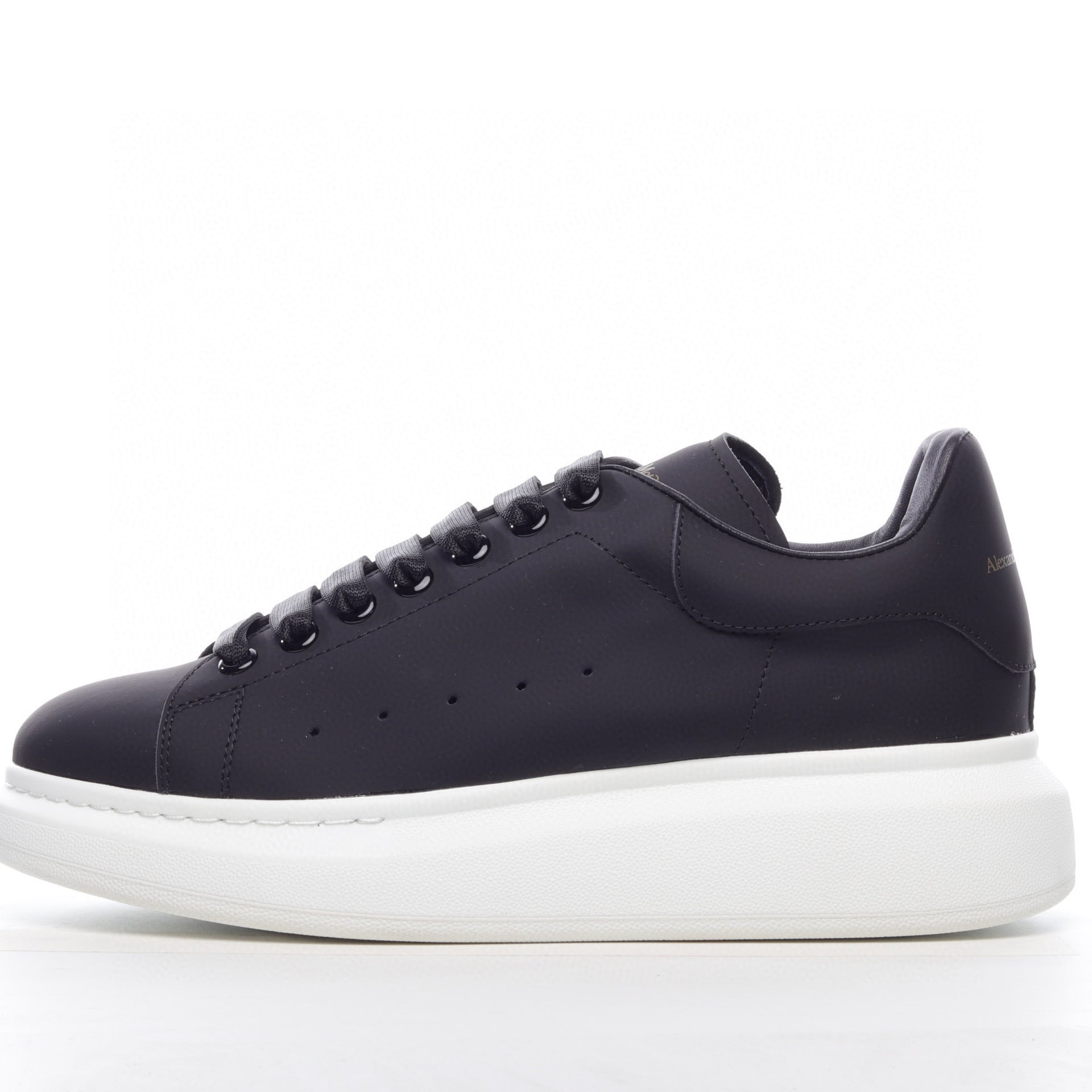 Black sneaker with white sole on a white background
