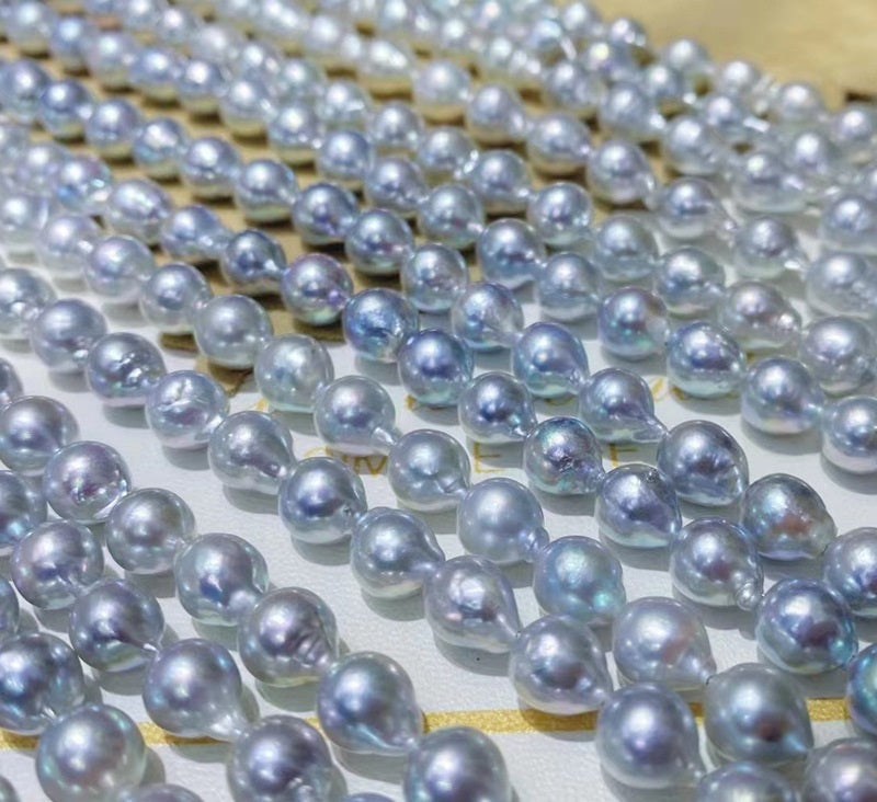String of blue pearls on a wooden surface