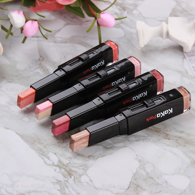 Set of KAPA makeup products on a marble surface with flowers in the background