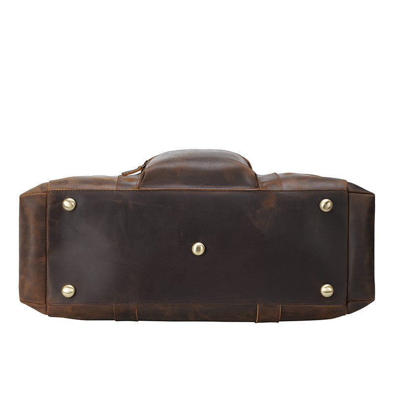 Brown leather bag with gold studs on a white background
