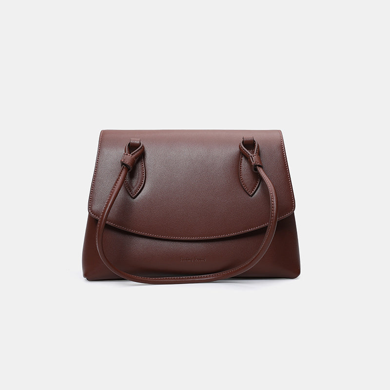 Brown leather handbag on a white background