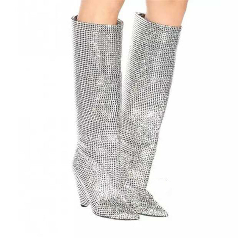 Silver rhinestone knee-high boots on a white background