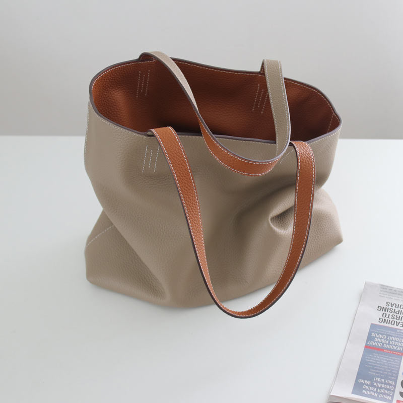 Beige tote bag with brown accents on a white surface