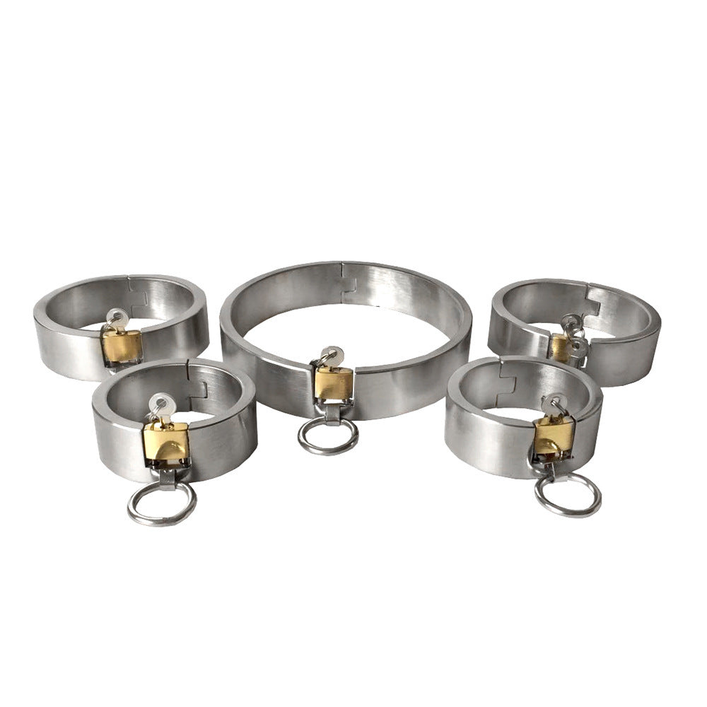 Set of metal chastity devices on a white background
