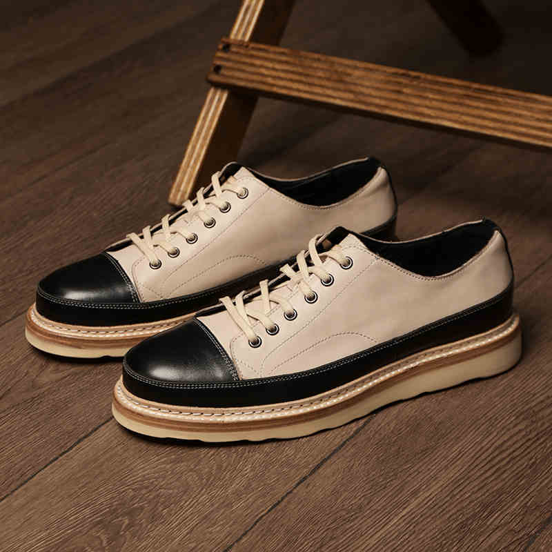 Pair of black and white sneakers on a wooden floor