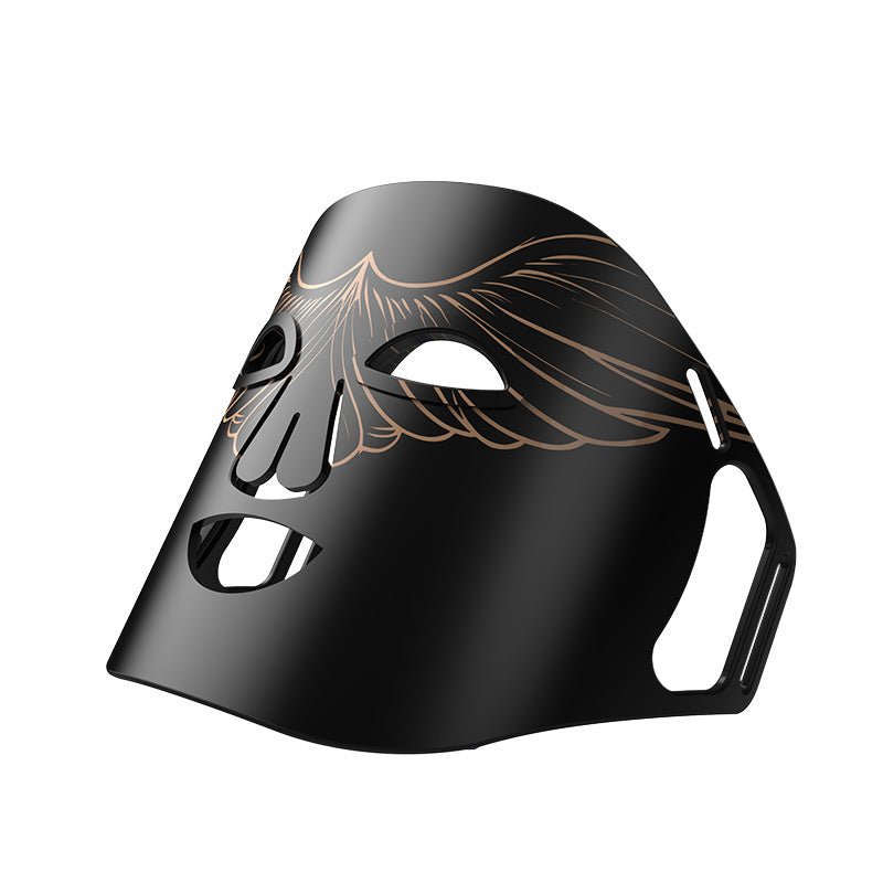 Black mask with gold detailing on a white background