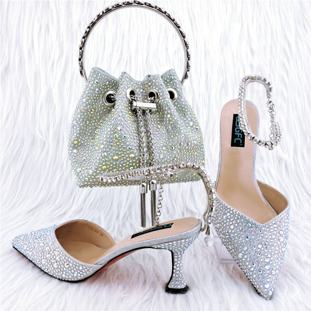 Silver studded handbag and high-heeled shoes on a white background