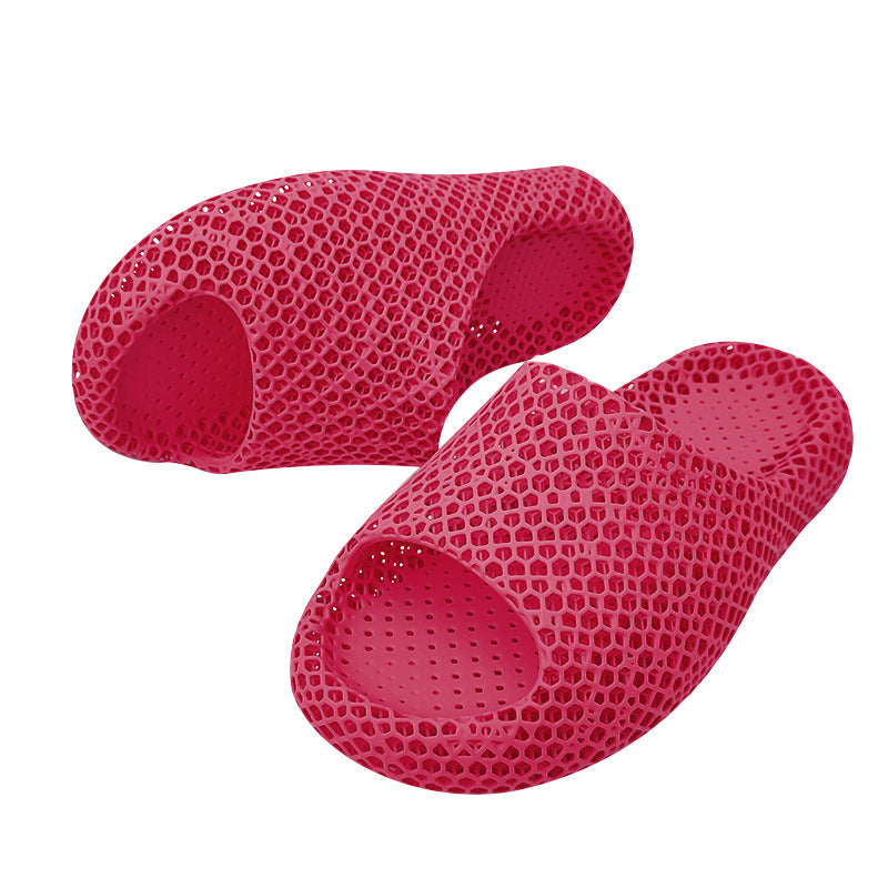 Two red honeycomb-patterned slippers on a white background