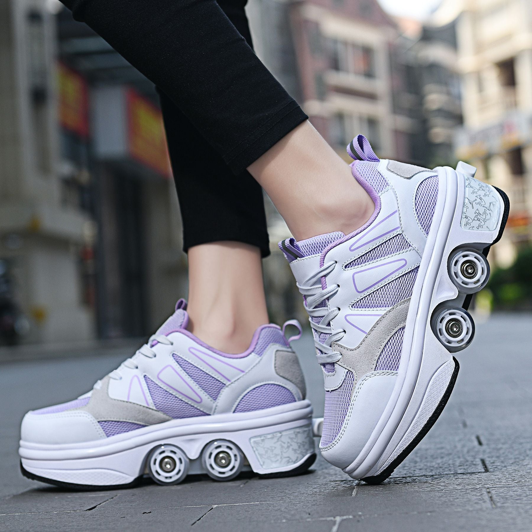 Purple and white sneakers with roller wheels on a blurred street background
