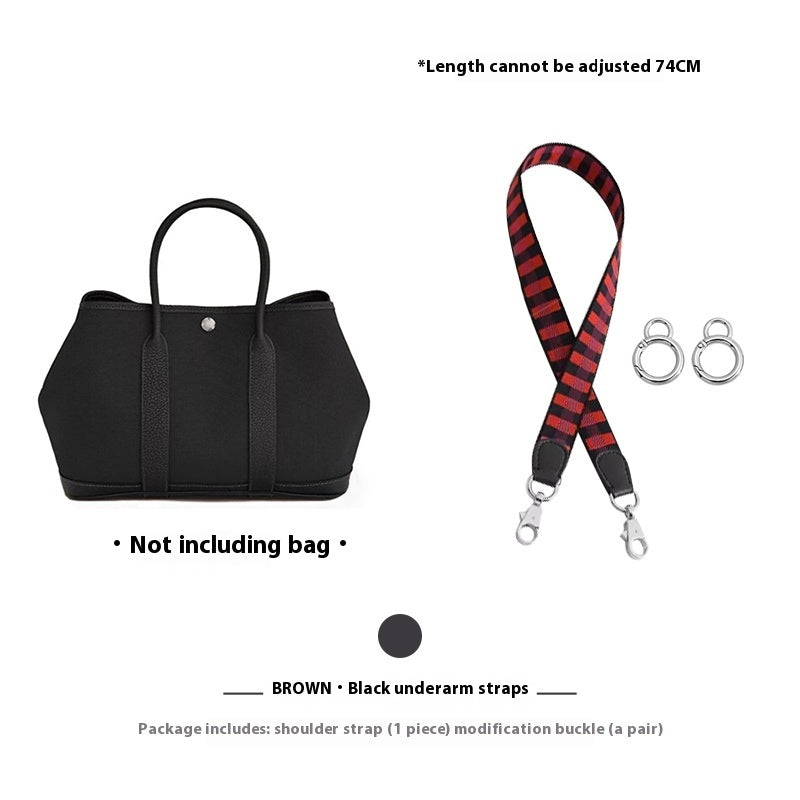 Black bra with red and black striped shoulder strap and buckles on a white background