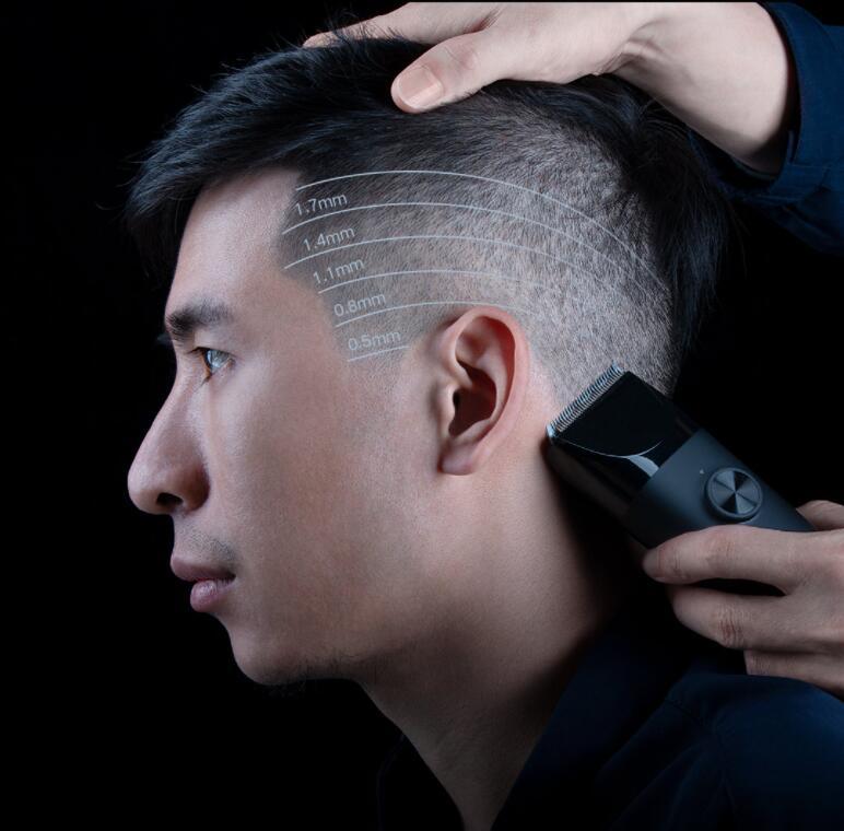 Man using a hair trimmer with hairline measurements on a black background