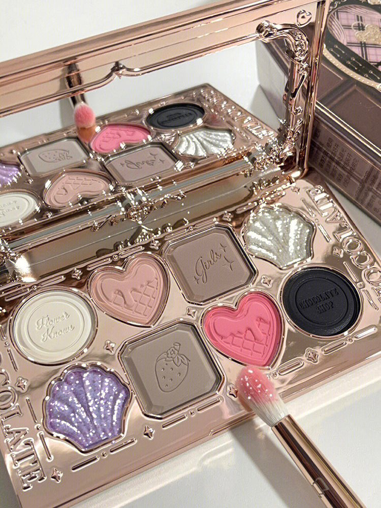 Makeup palette with heart and shell designs on a white background