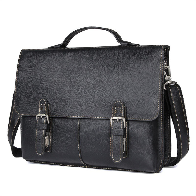 Black leather briefcase with shoulder strap on a white background