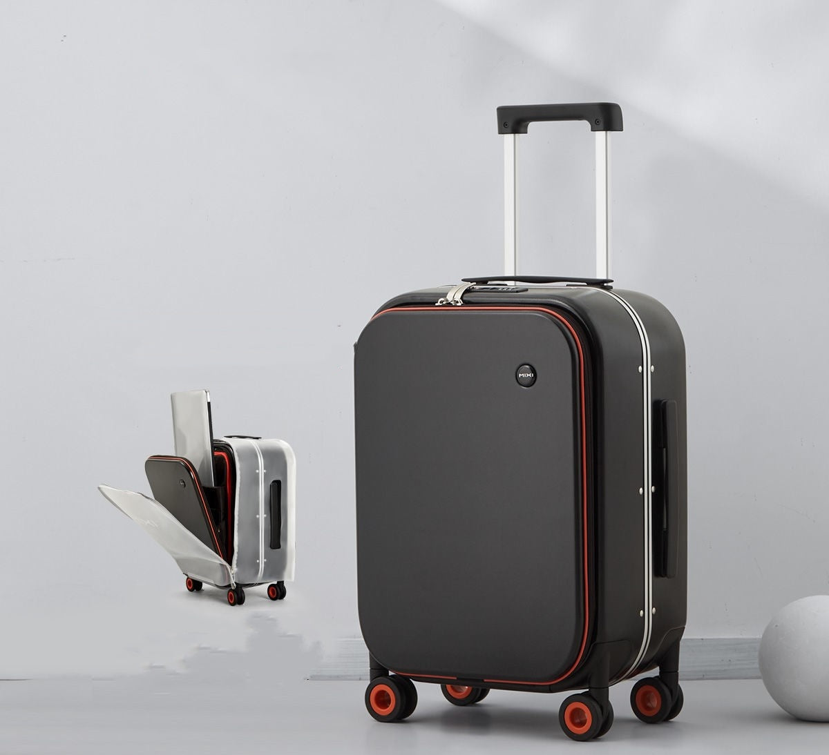 Black suitcase with red accents on a light gray background