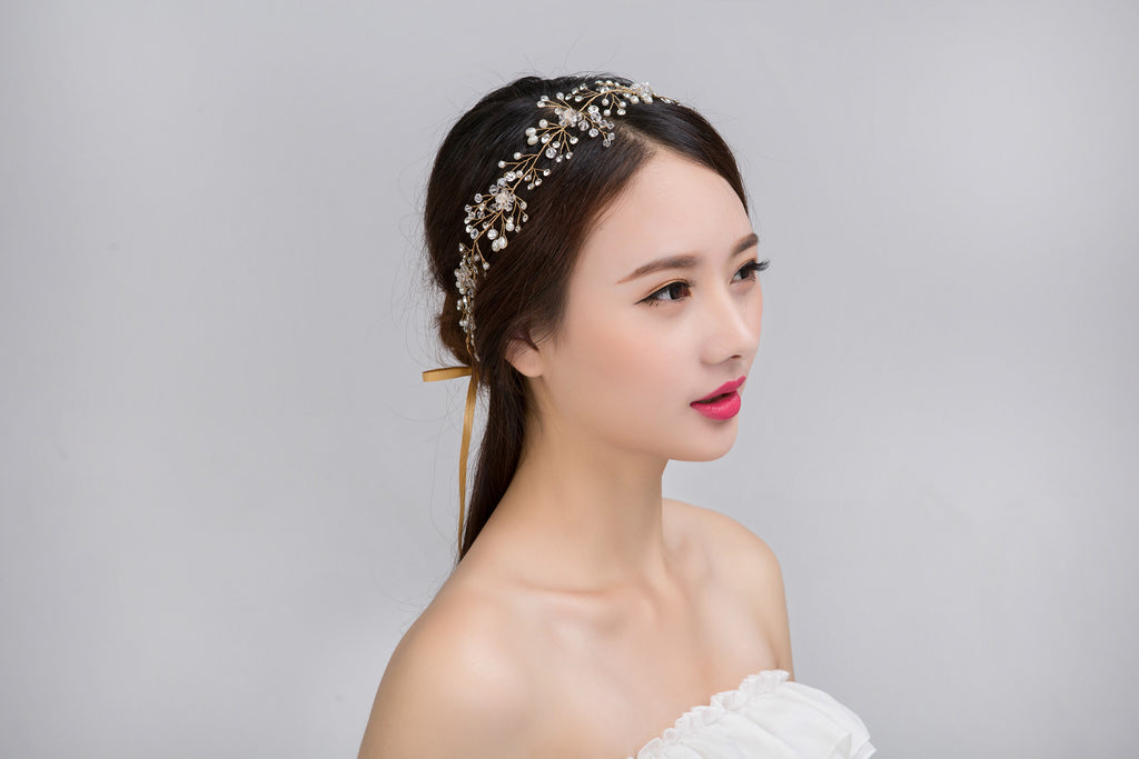 Woman wearing a decorative headband against a gray background