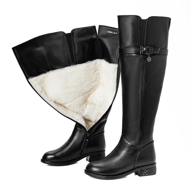 Black knee-high boots with white fur lining on a white background