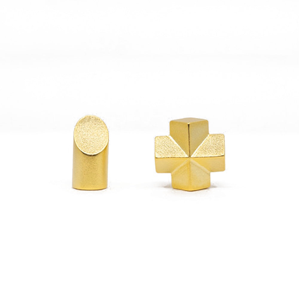 Two gold geometric earrings on a white background