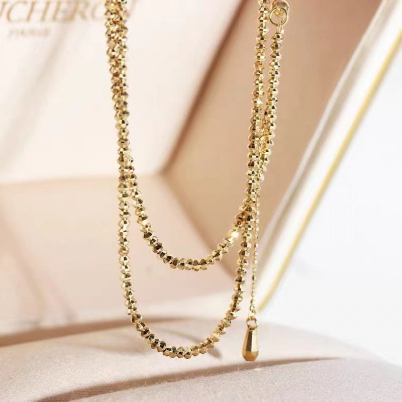 Gold necklace on a soft beige background