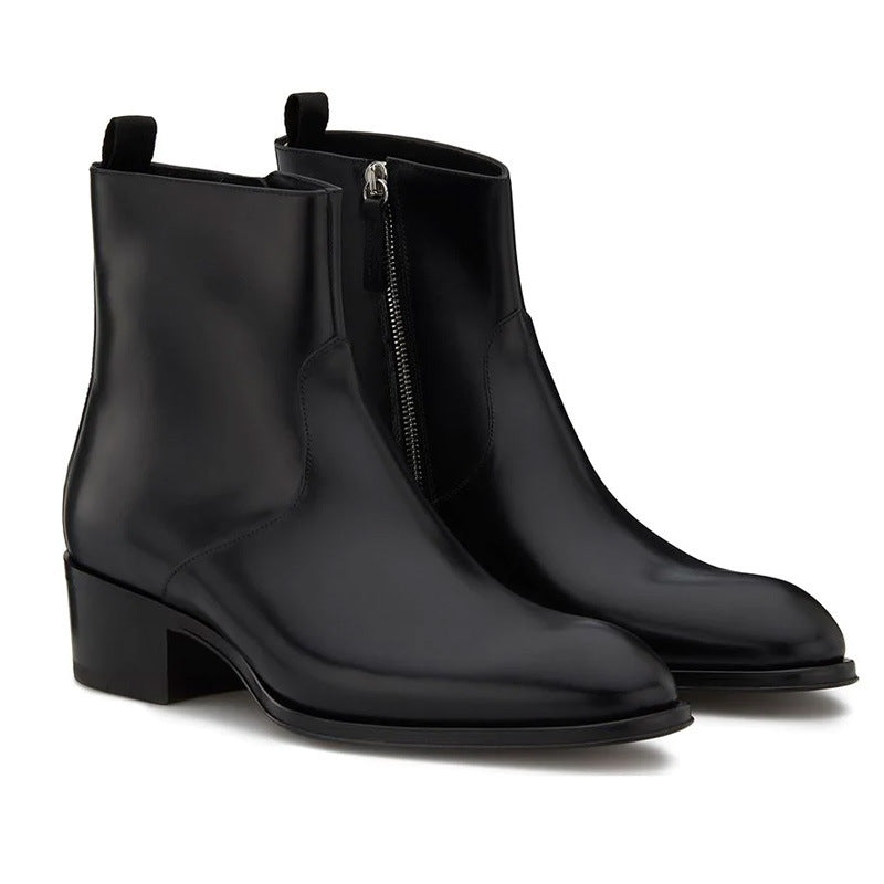 Pair of black leather ankle boots with zipper on a white background