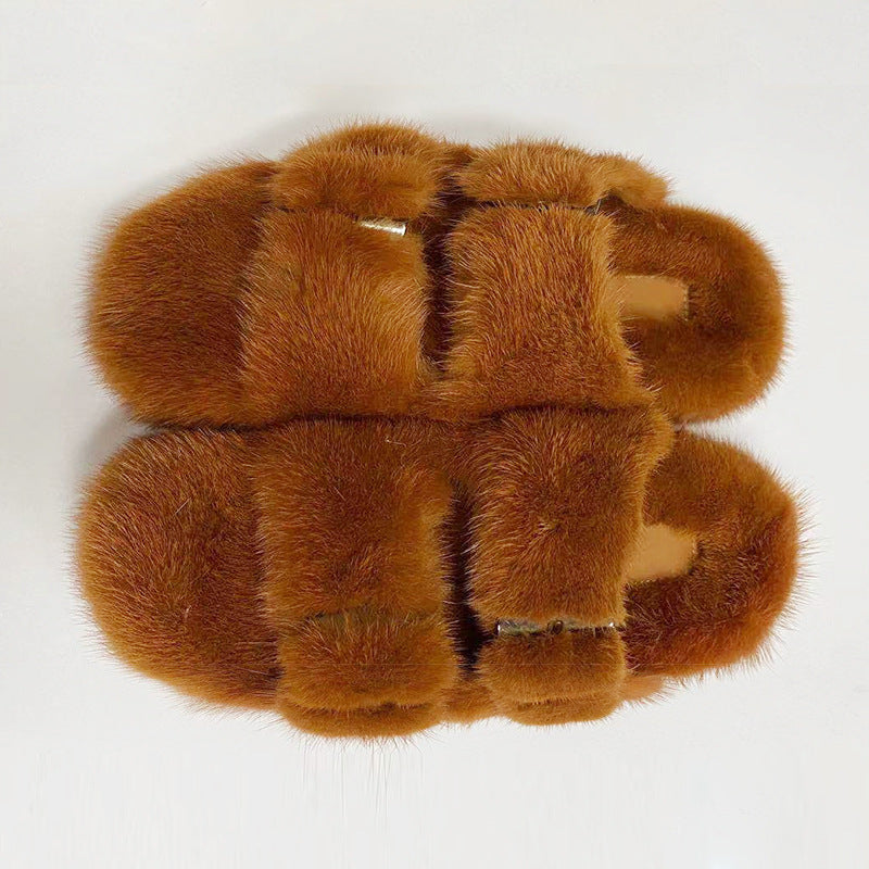 Pair of brown fur slippers on a white background