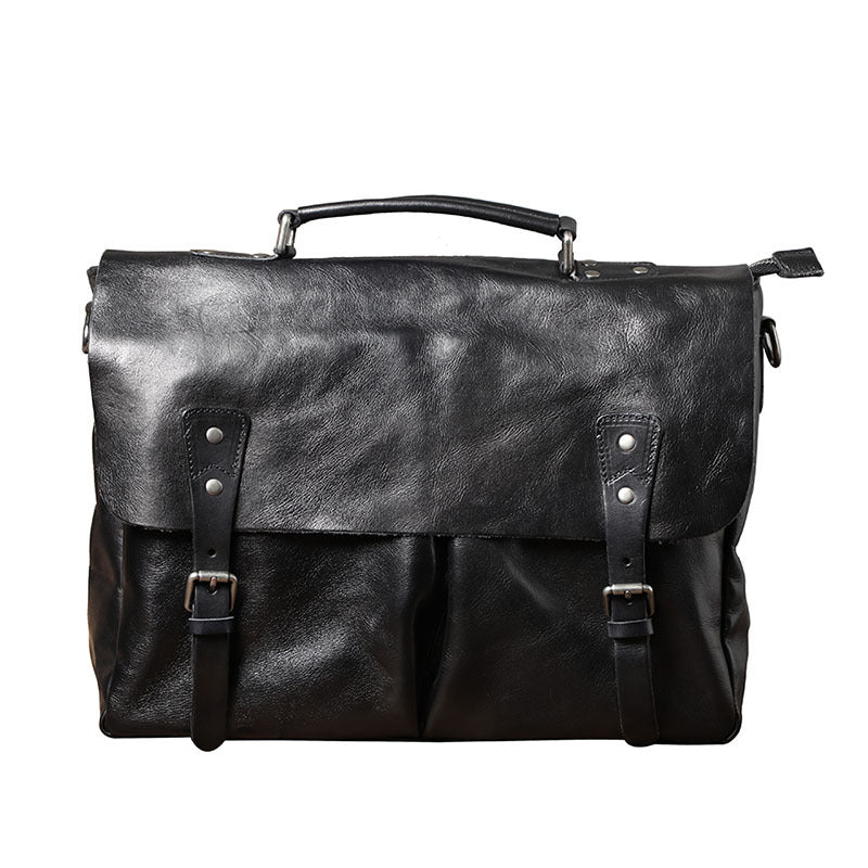 Black leather satchel bag with straps on a white background