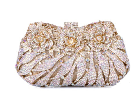 Decorative clutch bag with intricate design and sparkling stones on a white background