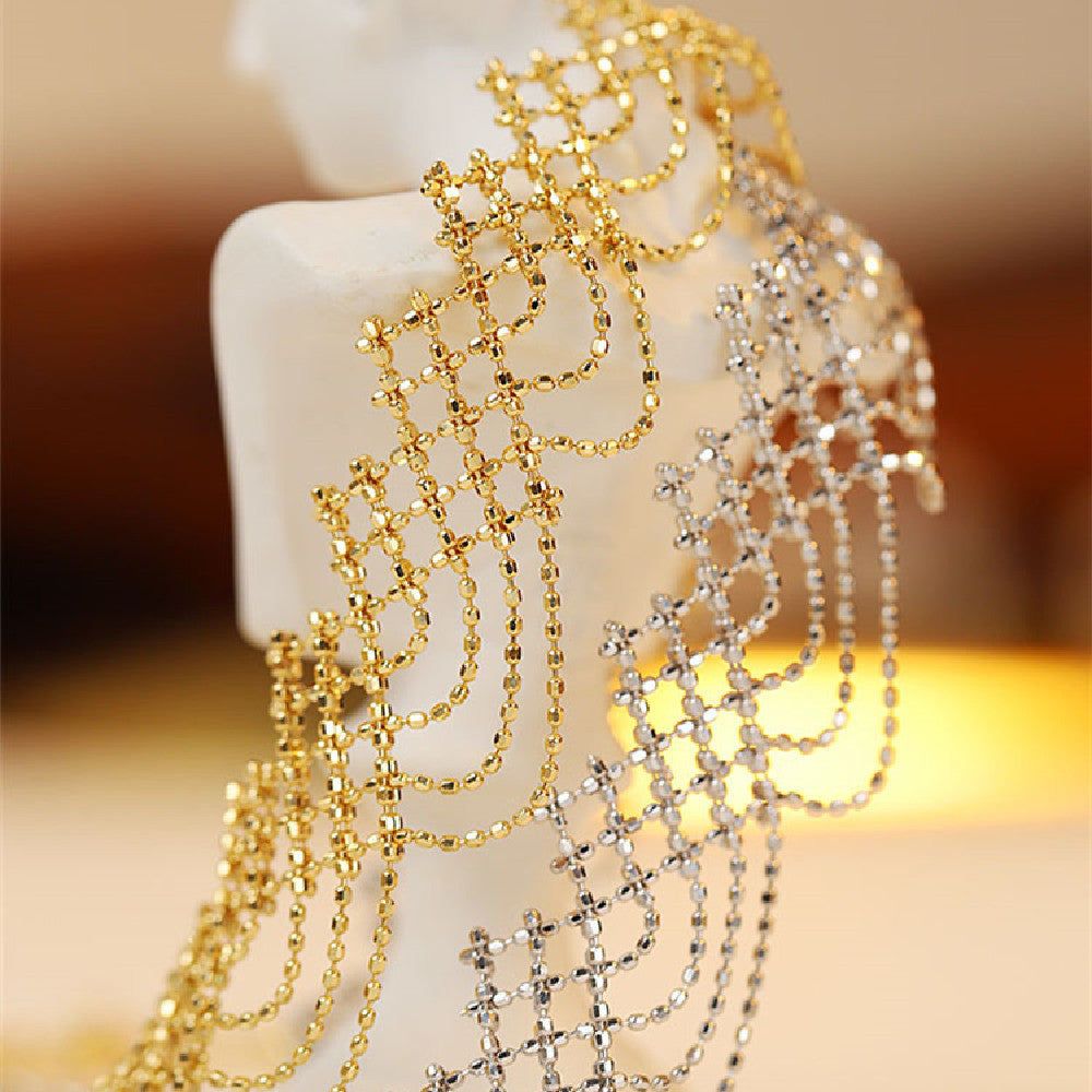 Gold and silver necklaces on a white stand with a blurred background