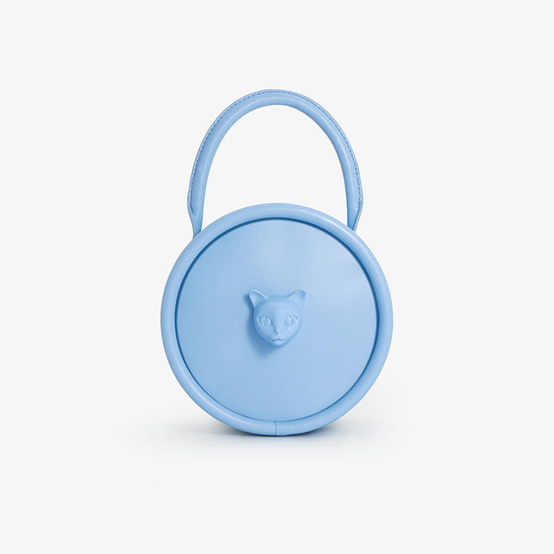 Blue round container with a handle and bear face emblem on a white background