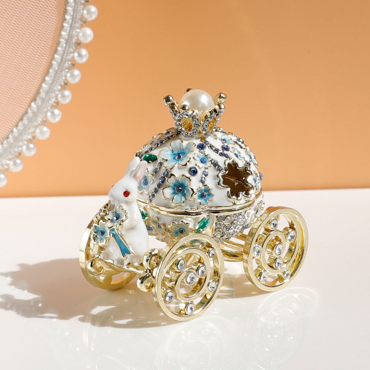 Decorative car-shaped box with intricate details on a light background