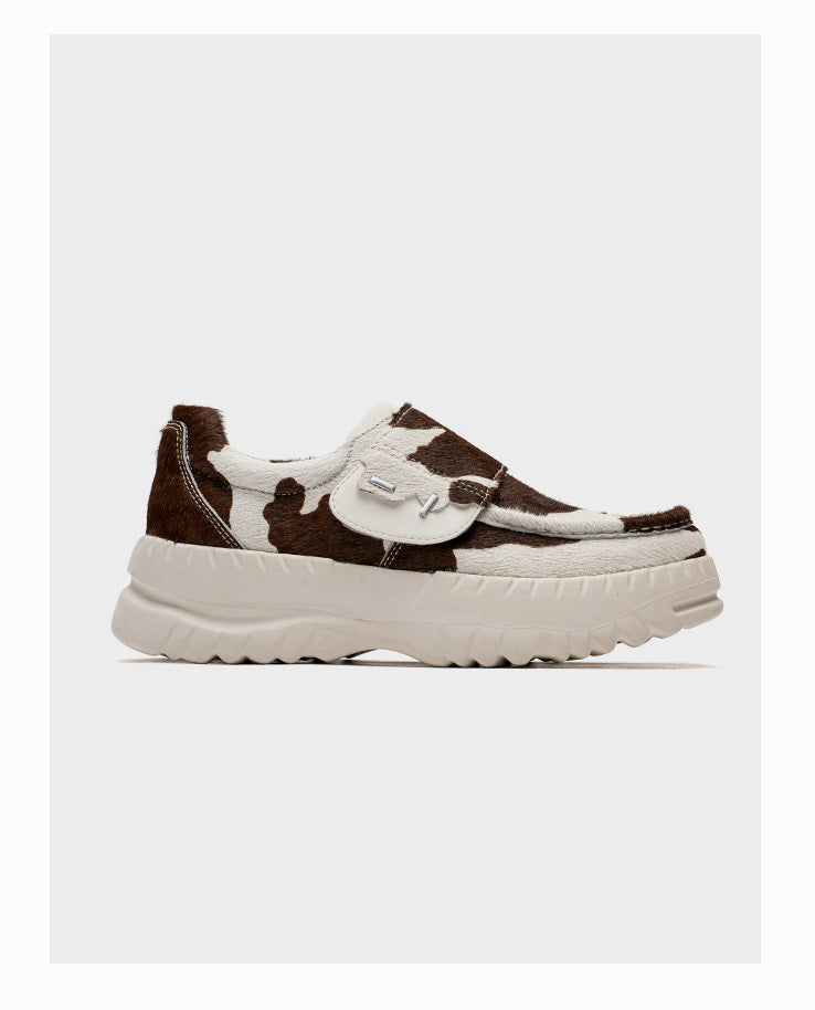 Brown and white sneaker on a light gray background
