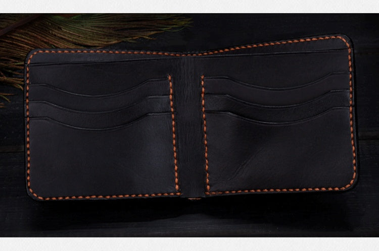 Black leather wallet with brown stitching on a dark background