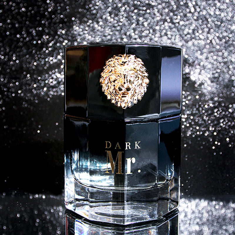 Black perfume bottle with gold lion emblem and 'Dark Mr.' text on a glittery black background