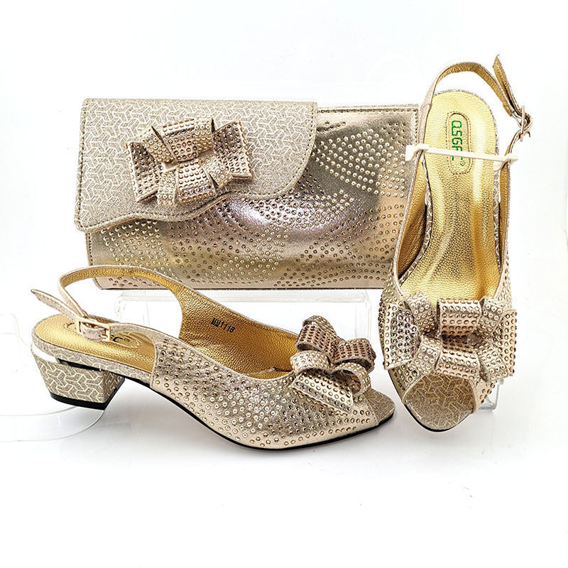 Gold shoes and matching handbag with bow detail on a white background