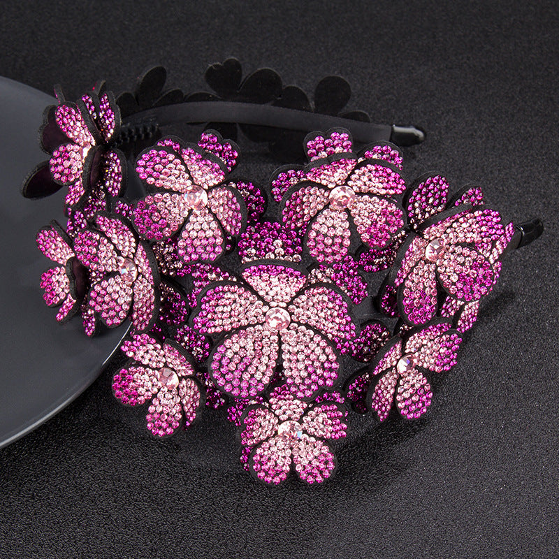 Decorative headband with pink floral embellishments on a black background