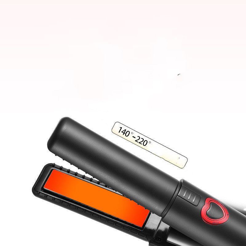 Black hair straightener with orange heating plate on a white background