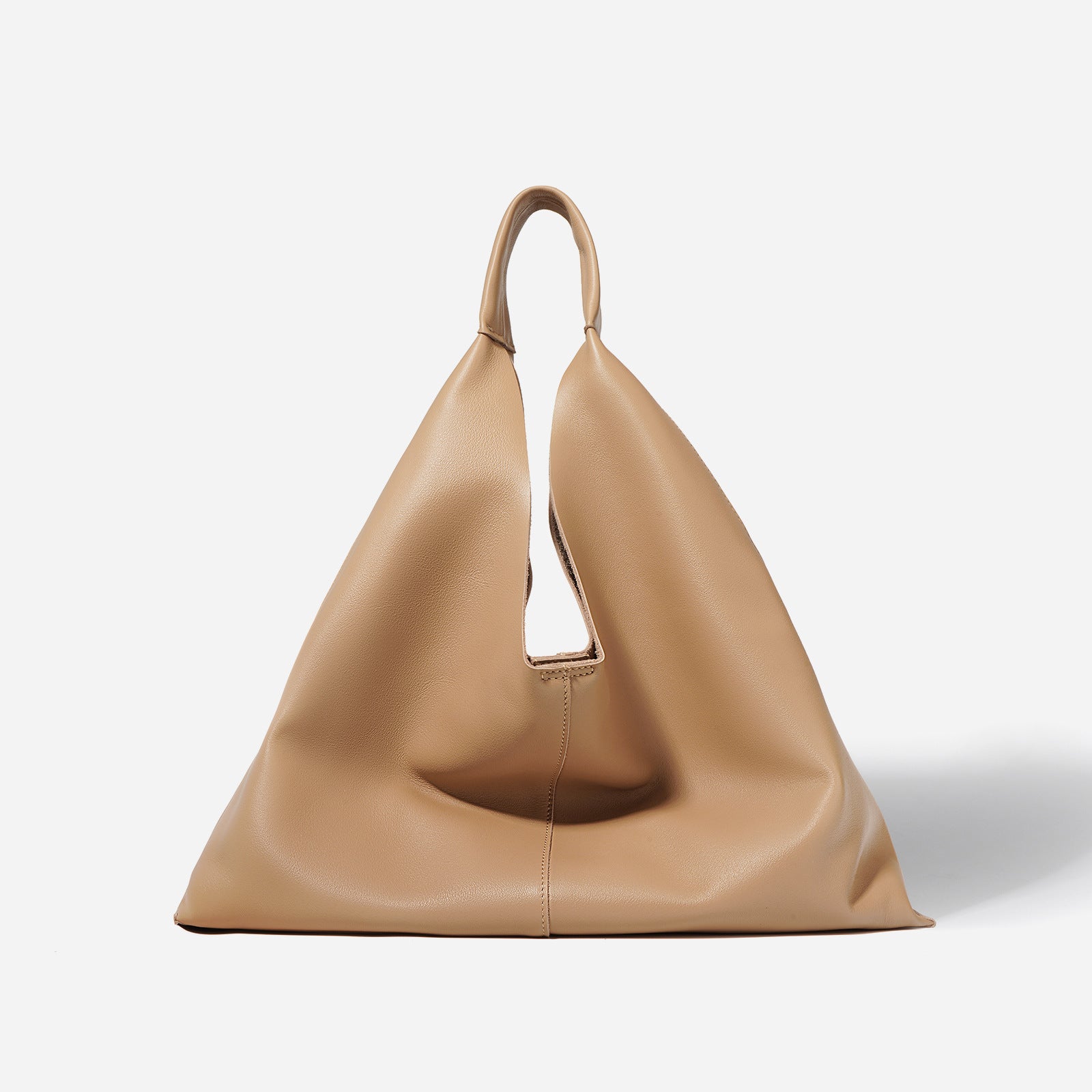 Tan leather handbag on a white background