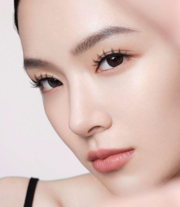 Close-up of a person's face with a neutral background