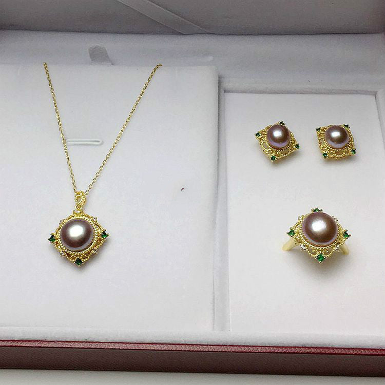 Pearl jewelry set with necklace and earrings on a white display box