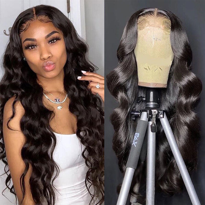 Woman with long wavy hair next to a wig on a mannequin head.
