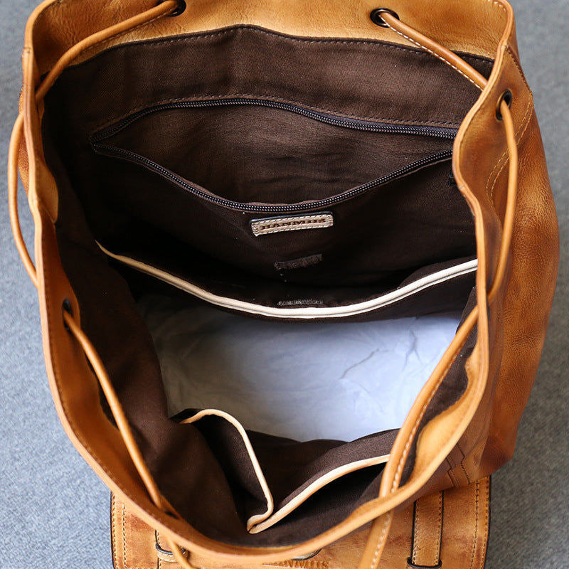 Brown leather bag with open front, showing interior on a gray background